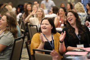 Attendees laughing and clapping in session at 2024 NCRA Conference & Expo