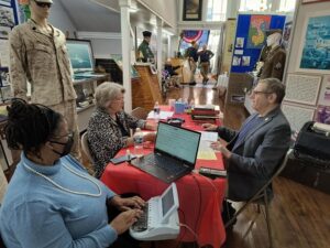 Veteran, interviewer, and stenographer at a VHP event in Manassas