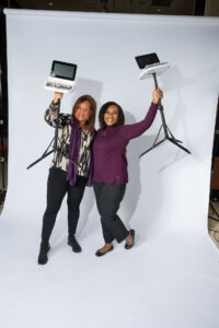 Reporters smiling and holding their steno machines in the air