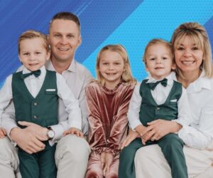 Smiling parents and young children posing for a picture